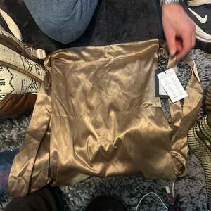 Reigns By Savannah Fellers Satin Backpack Color: Amphora